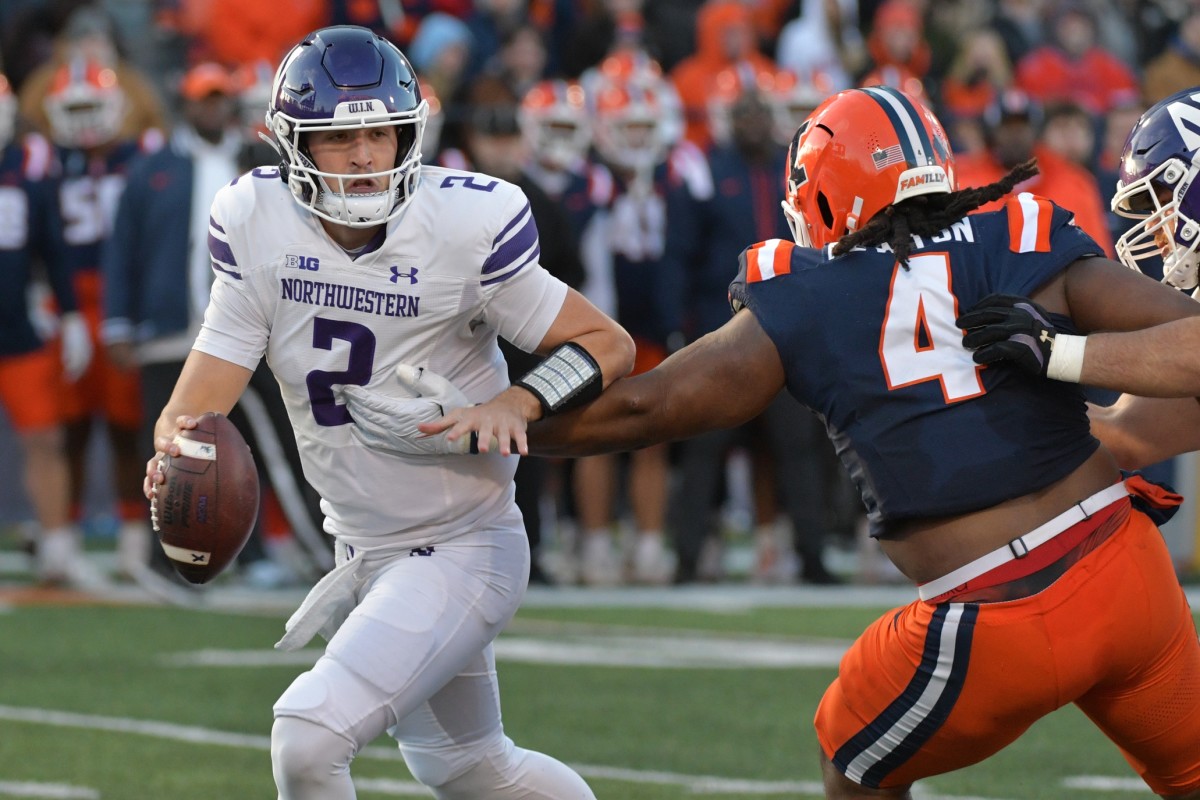 Nov 25, 2023; Champaign, Illinois, USA; Illinois Fighting Illini defensive tackle Jer'Zhan Newton (4) sacks Northwestern Wildcats quarterback Ben Bryant (2) during the first half at Memorial Stadium.